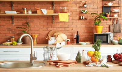 Cooking utensils and products on table in modern kitchen