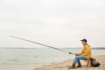 Teenage boy fishing on river