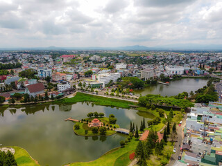 Fototapeta na wymiar Aerial view of small Dong Nai lake - a central lake in Bao Loc city, Lam Dong province, Vietnam. It is a nice beside big TV tower.