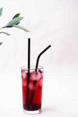 Refreshing berry juice with ice. Minimalistic still life of a summer cocktail.