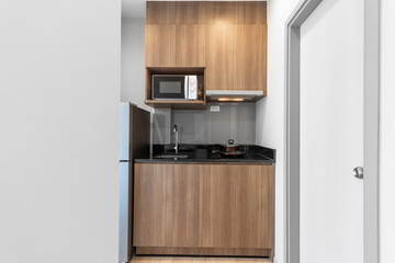 Wood Kitchen with Microwave and Electric Stove in Apartment 