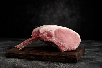 Raw fesh pork meat with bones on wooden board