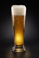 Mug with fresh beer with cap of foam on a black.
