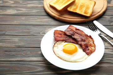 Eggs and bacon for breakfast on brown background. with copy space.
