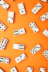 Playing dominoes on a orange table. Domino effect