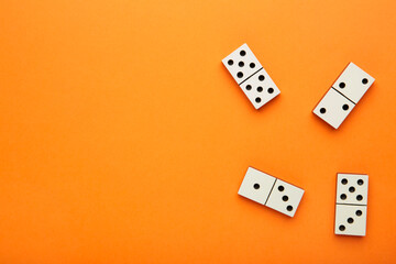 Domino pieces on the orange background with copy space. Game