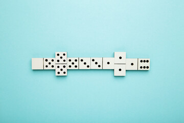 Playing dominoes on a blue background . Domino effect