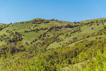 Fototapeta na wymiar Beautiful Summer Mountain Landscape with Green Meadows and Hills .Babintsi Village in Teteven,Bulgaria 