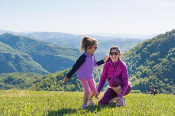 Mother and Kid in the Summer Mountain 