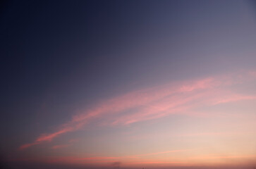 A lonely sunset dusk against a long cloud backdrop.