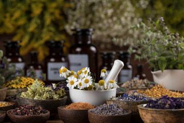 Natural medicine and mortar, healing herbs background
