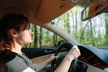 The woman driving the modern car
