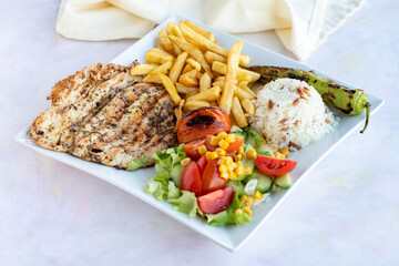 Grilled chicken. Served with potatoes, rice and salad