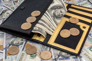 leather wallet with us dollar and cent  on white wooden desk
