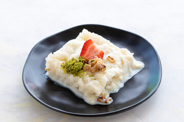 Gullac on a white background. Traditional Ramadan dessert. Milk dessert. Local name Güllaç