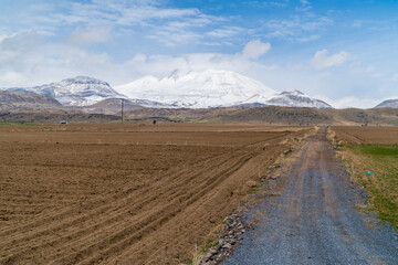 Panoramic view of a field in a rural part of central Turkey with Mount Erciyes in the background