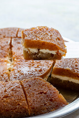 Creamy bread dessert on a white background. Local name kaymaklı ekmek kadayıfı