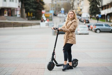 Young woman on electro scooter in city.