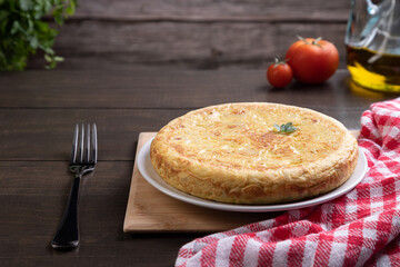 Traditional Spanish omelette dish, on rustic background with copy space. Spanish cuisine.
