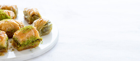 Mixed baklava plate on marble plate. Copy space