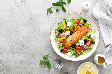 Salmon fish salad. Fresh vegetable greek salad with tomato, pepper, lettuce, olives, cucumbers,...