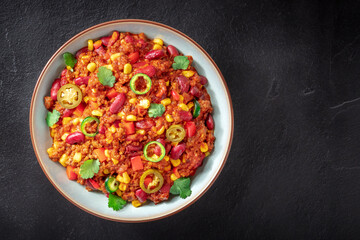 Chili con carne, Mexican beef stew with beans and peppers, shot from the top