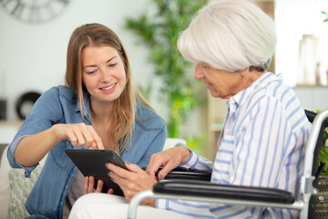 health visitor and a senior woman with tablet