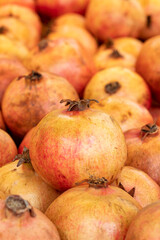 fresh pomegranate in the market. pomegranate in bulk. ripe pomegranate in a street market