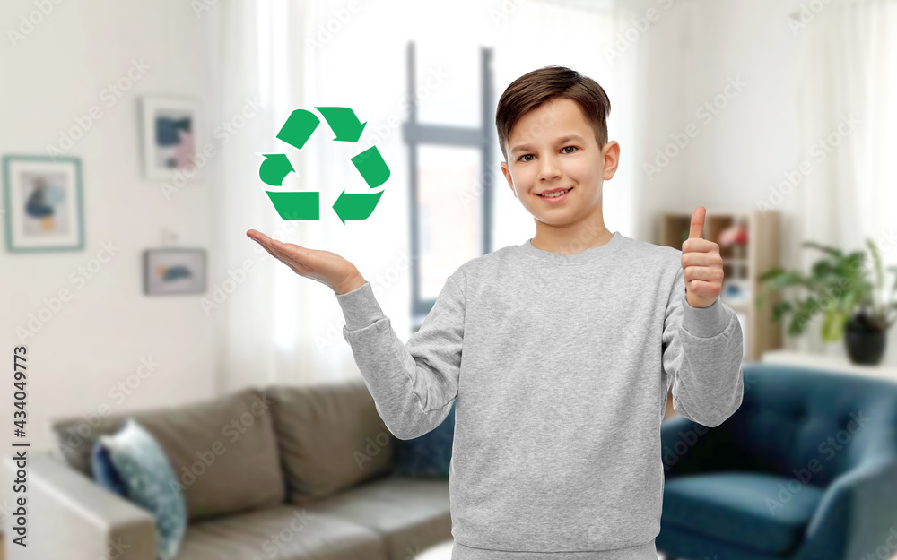 Canvas Prints eco living, environment and sustainability concept - smiling boy holding green recycling sign and showing thumbs up over home room background