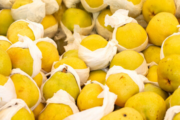 fresh pears in the market. pears in bulk. ripe pears in a street market