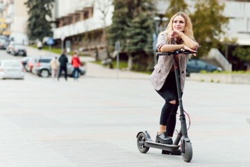 Girl in electric scooter riding in the old city center