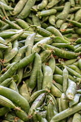 fresh peas in the market. peas in bulk. ripe peas in a street market