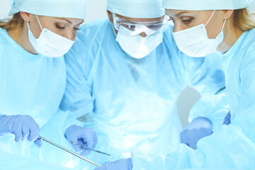 A group of surgeons is operating at the hospital. Health care concept