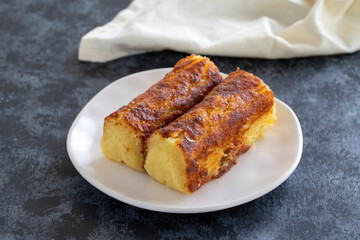 Cheese dessert on a dark background. Traditional Middle Eastern cuisine flavors. Cheese halva. Local name peynir helvası yada peynir tatlısı