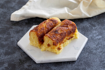 Cheese dessert on a dark background. Traditional Middle Eastern cuisine flavors. Cheese halva. Local name peynir helvası yada peynir tatlısı