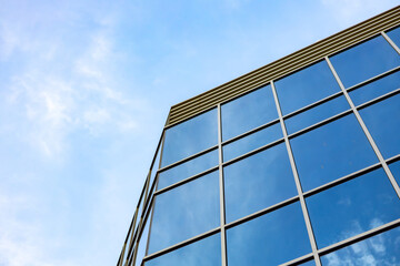 Plakat Glass skyscraper against blue sky, view from bottom