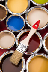 Tin cans with paint and brushes