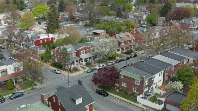 Descending aerial establishing shot of homes in city. Pedestal shot. Residential housing district in American urban city, USA.