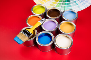 Colorful paint cans with paintbrush