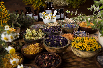 Homeopathy, herbal medicine on wooden table