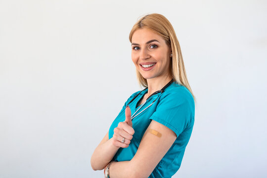 Vaccinated young Doctor, medical worker, nurse Woman Gesturing Thumbs-Up Approving Vaccination, white Background