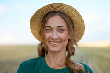 Woman farmer straw hat standing farmland smiling Female agronomist specialist farming agribusiness Happy positive caucasian worker agricultural field