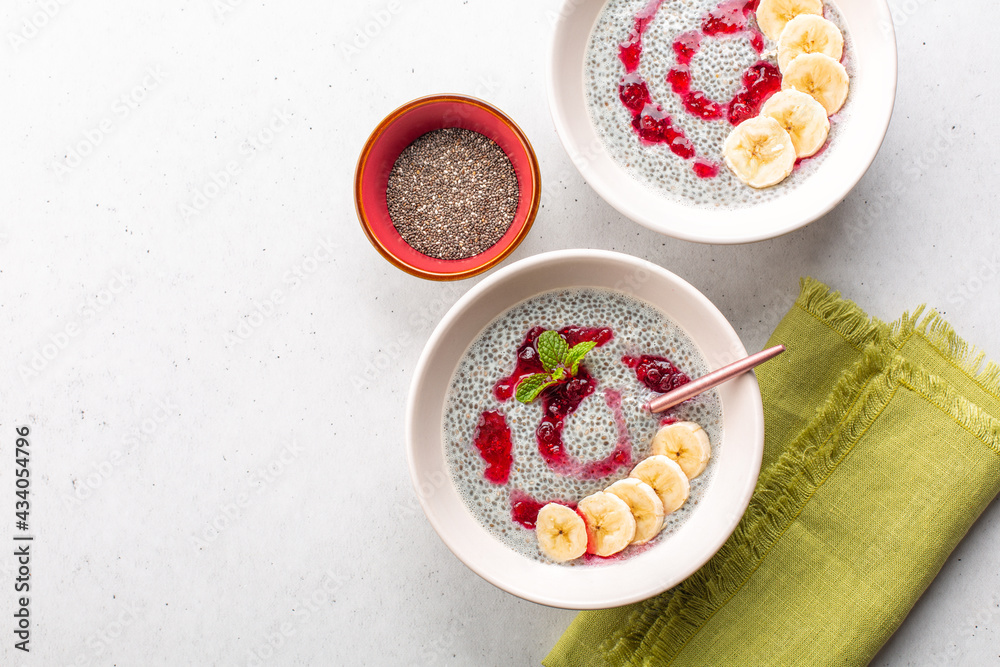 Wall mural Healthy chia pudding with coconut milk and fresh cranberry sauce, decorated with mint and raw chia seeds.