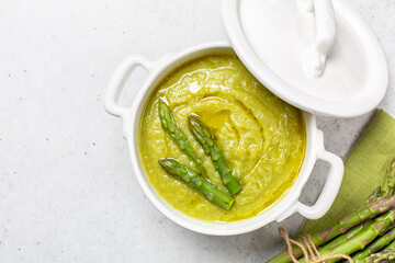 Top view of cream of asparagus soup. Prepared with asparagus, potato, onion and vegetable stock. Uncooked ingredient on bacground. Vegan.