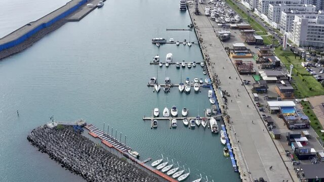 Aerial: Luxury boats and yahts standing near shore in grand marina
