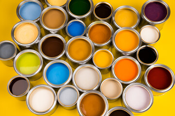 Buckets full of rainbow colored oil paint