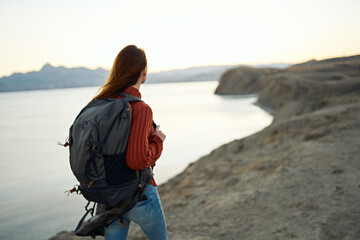 woman travels in the mountains outdoors near the sea cropped view portrait