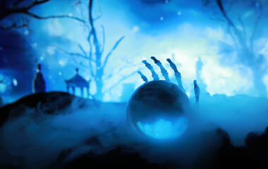 Skeleton Zombie Rising Out Of A GraveYard - Halloween. Mysterious magic ball predictions and smoke on dark scene.