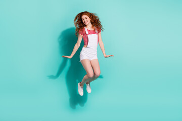 Full length body size view of charming cheerful girl jumping having fun good mood isolated bright blue color background