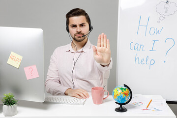 Employee operator business man in set microphone headset for helpline assistance sit work at call...